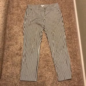 Cropped black and white striped dress pant.